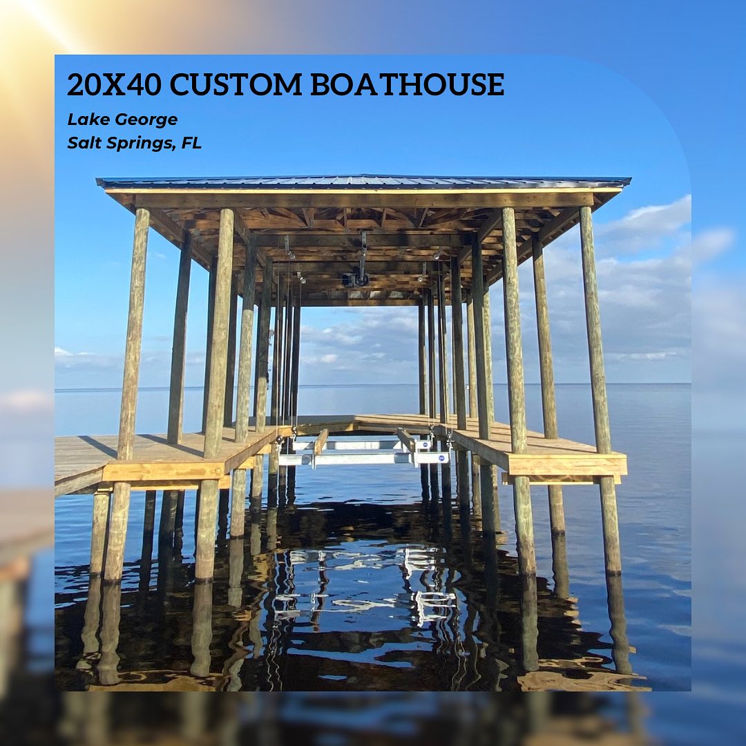 466972622_17907356226049257_4887691340780656531_n - JSC Contracting Inc Wooden boathouse frame on pilings over a calm lake; text reads '20X40 CUSTOM BOATHOUSE' and 'Lake George, Salt Springs, FL'.